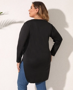 Detail view of the high side slit design and hemline on this plus size long sleeve top