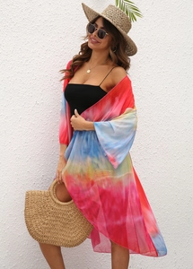 Detailed texture of vibrant tie-dye chiffon fabric on a flowy beach cover-up cardigan