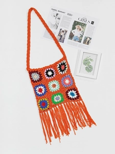 Detail of colorful crochet shoulder bag with bohemian fringe and granny square patterns