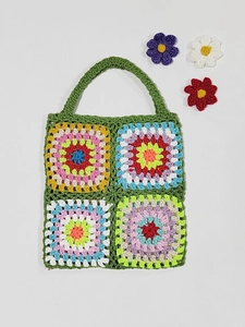 Detail of handmade granny square crochet tote bag with vibrant multi-color patchwork patterns