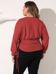 Detail of waist drawstring and pleated texture on a dark red asymmetric casual sweatshirt