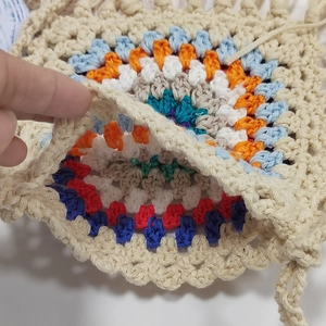 Detailed close-up showing the intricate granny square crochet texture and inner lining