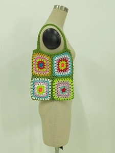Detail of colorful granny square crochet tote bag with vibrant hand-woven wool texture