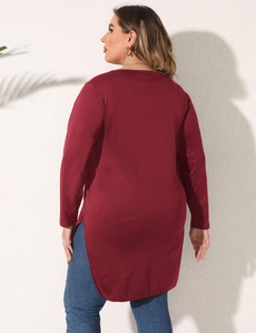 Detail of burgundy long sleeve top showing the high-low hem and textured burnout fabric