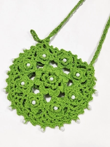 Handmade green crochet crossbody phone bag with hollow flower patterns and pearls
