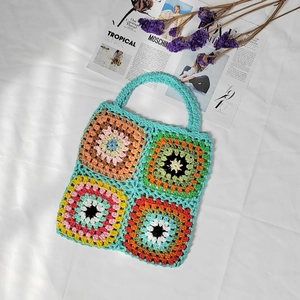 Detailed close-up of colorful crochet grandmother squares and knit floral patterns