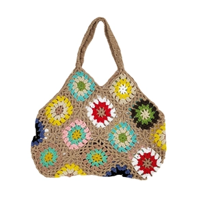 Handmade crochet tote bag with colorful bohemian flower patterns on khaki knit