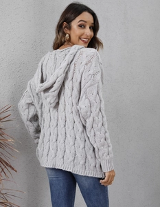 Close-up detail of grey cable knit hooded cardigan showing thick texture and pattern