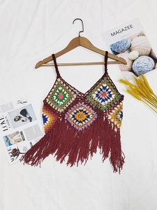 Close-up of handmade crochet bohemian camisole featuring colorful patchwork and long fringe