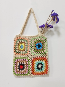Close-up of handmade crochet granny square tote bag with colorful patchwork patterns
