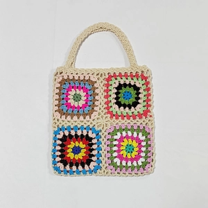 Detail of colorful granny square crochet handbag with hand-knitted bohemian patterns