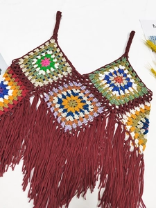 Close-up detail of bohemian crochet halter top with colorful patchwork and tassel fringe