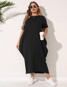 Detail of loose fit plus size black maxi dress with side pockets and asymmetric hem