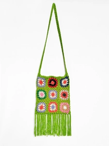 Detailed macro view of handmade granny square crochet shoulder bag with colorful tassels