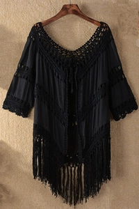 Close-up of black bohemian crochet knit hollow-out beach cover-up with long tassels