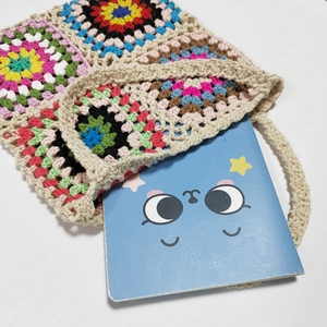 Handmade granny square crochet tote bag with vibrant bohemian colorful patterns