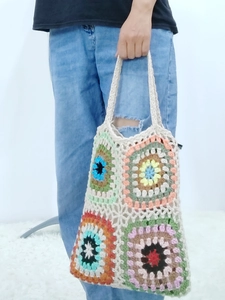 Detail of handmade crochet granny square tote bag with colorful bohemian pattern