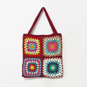 Detailed close-up of handmade crochet granny square handbag with colorful woven patterns