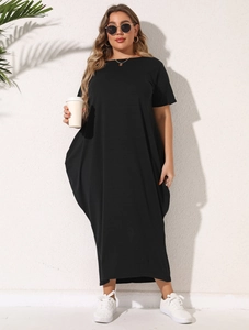 Detail of short sleeves and pockets on a loose black plus size maxi dress for women