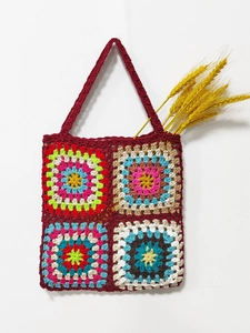 Detailed close-up of handmade crochet granny square tote bag with colorful patchwork patterns