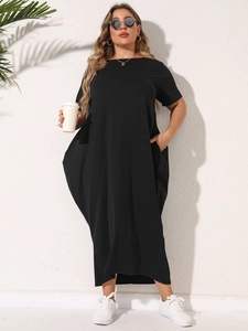 Plus size black short sleeve maxi dress with pockets and loose minimalist silhouette