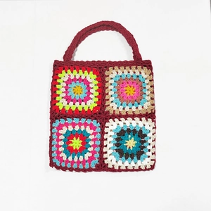 Macro detail of wine red crochet tote bag featuring vibrant handmade granny squares pattern