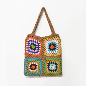 Close-up of colorful crochet granny squares on a retro brown woven tote bag