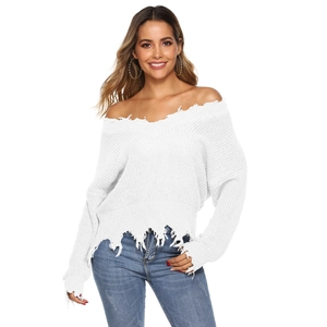 Detail of white off-shoulder knit sweater with distressed frayed edges and ripped hem