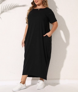 Detail of plus size black maxi dress showing practical side pockets and soft knit fabric