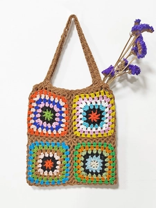 Detailed close-up of handmade crochet granny square tote bag in warm earthy tones