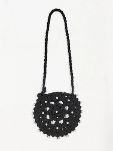 Detail of hand-crocheted black crossbody bag featuring floral patterns and white beads