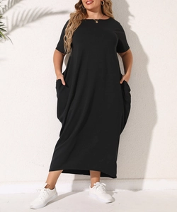 Detail of plus size black cotton maxi dress showing functional pockets and relaxed fit fabric