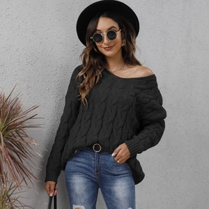 Close-up of the thick cable knit texture and V-neck design on this black oversized sweater