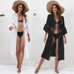 Close-up of white and black lace beach cover-up with hollow crochet knitting detail