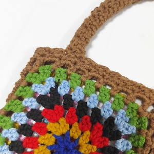 Close-up of handmade crochet tote bag featuring vibrant ethnic pattern stitching