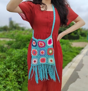 Bohemian crochet crossbody bag with colorful granny square patterns and long tassels