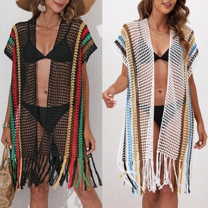 Detail of crochet beach cover-ups with colorful stripes and handmade tassels in black and white