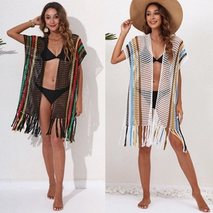 Detail of crochet beach cover-up with colorful vertical stripes and fringed hem design