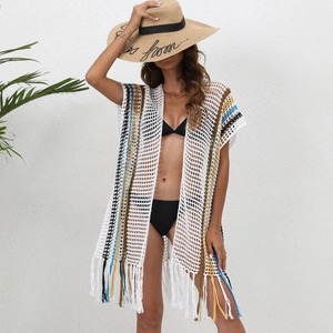 Detailed view of bohemian crochet beach cover-up with colorful stripes and fringe hem