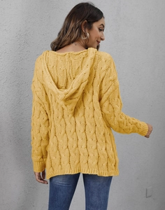 Detailed close-up of yellow cable-knit texture and hood on a relaxed fit women's sweater