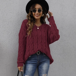 Detail of burgundy cable knit V-neck hoodie sweater with loose fit and thick texture