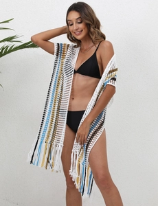 Detail of white crochet beach cover-up with colorful stripes and long fringe tassels