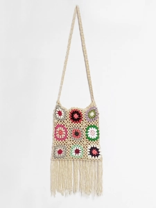 Detail of bohemian crochet crossbody bag with floral granny squares and fringe tassels