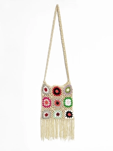 Detailed macro shot of bohemian crochet bag with colorful floral squares and long fringe