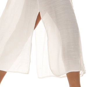 Detailed close-up showing the textured white fabric and high side slit of the beach dress