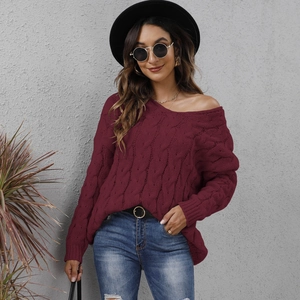 Detail of burgundy chunky cable knit texture on an off-shoulder hooded sweater