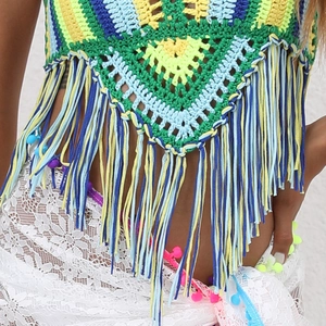 Detailed view of colorful handmade crochet bohemian top with long fringe tassels