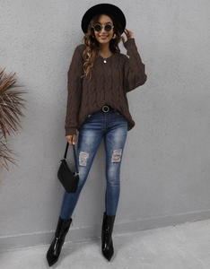 Close-up of deep brown chunky cable-knit sweater with a stylish V-neck design