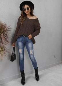 Brown cable knit hooded sweater paired with ripped blue jeans and black boots