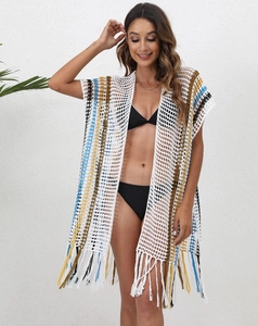 Close-up of crochet knit beach cover-up featuring colorful stripes and fringe hem